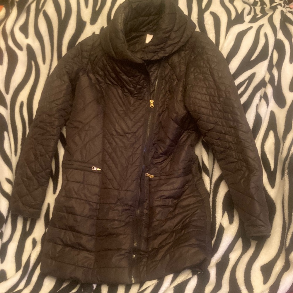 Beautiful black jacket with a symmetrical zipper. No holes or rips or tears